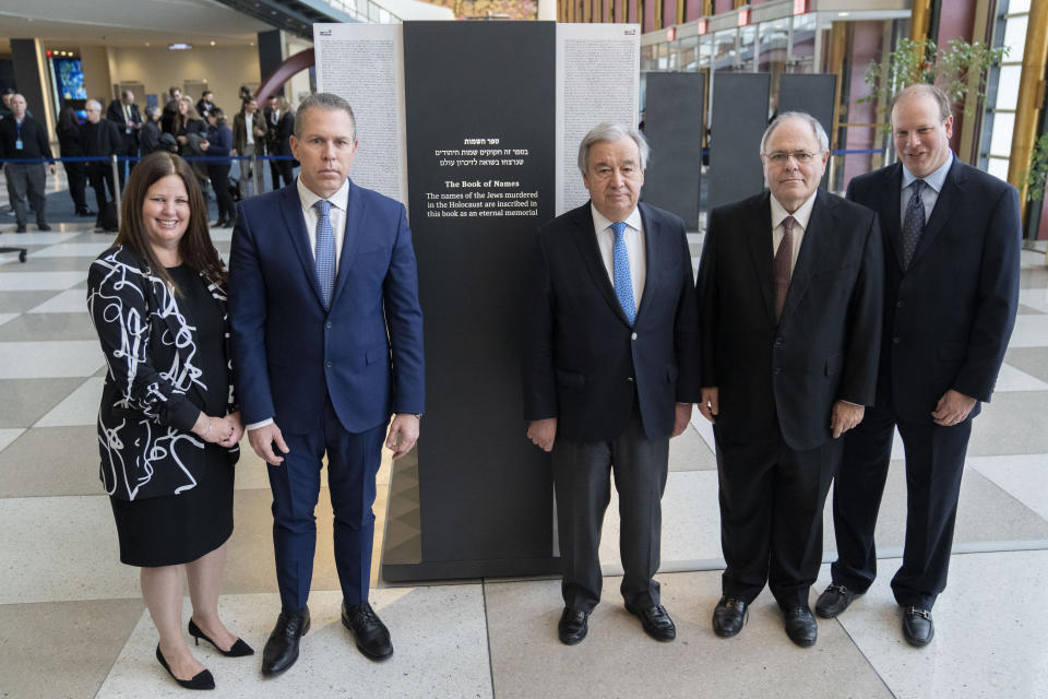 From left, Ms. Rebecca Altman, Gilad Erdan, Permanent Representative of Israel to the United Nations, Antonio Guterres, United Nations Secretary General, Dani Dayan, Chairman of Yad Vashem, and Brian Rubenstein gather for a photograph in front of the Yad Vashem Book of Names of Holocaust Victims Exhibit, Thursday, Jan. 26, 2023, at United Nations headquarters. (AP Photo/John Minchillo)