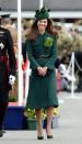 <p>In 2014, the Duchess looked bronzed from her recent holiday with the Duke of Cambridge in the Maldives. She covered up in a Hobbs coat, and wore her sun-kissed locks loose in soft waves. Again, Kate pinned on the Queen Mother’s brooch for the occasion. (Photo: PA) </p>