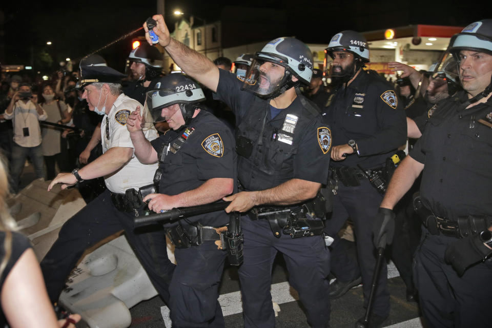 FILE - Police scuffle with protesters in the Brooklyn borough of New York, May 30, 2020, during a protest in response to the death of George Floyd, a Black man who was killed in police custody in Minneapolis. New York City’s police department has agreed to adopt new policies intended to safeguard the rights of protesters as part of a legal settlement stemming from its response to the Black Lives Matter demonstrations in 2020. The 44-page agreement, filed Tuesday, Sept. 5, 2023, in Manhattan federal court, requires the nation’s largest police department to deploy fewer officers to most public protests. (AP Photo/Seth Wenig, File)