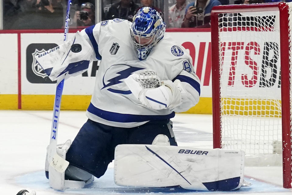 Tampa Bay Lightning goaltender Andrei Vasilevskiy blocks a Colorado Avalanche shot during the third period of Game 1 of the NHL hockey Stanley Cup Final on Wednesday, June 15, 2022, in Denver. (AP Photo/John Locher)