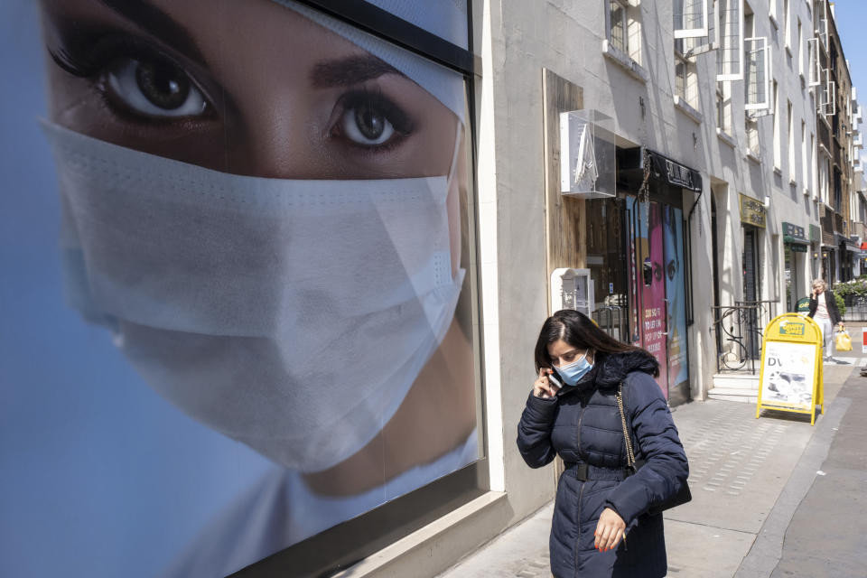 Picture of a model wearing a face mask adorns an advertisement for medical premises in Marylebone on 10th August 2021 in London, United Kingdom. Passing people interract with the large scale photo poster of a woman with beautiful eyes looking out from above her face covering, which has direct connotations during these times where coronavirus / Covid-19 affects daily life. (photo by Mike Kemp/In Pictures via Getty Images)