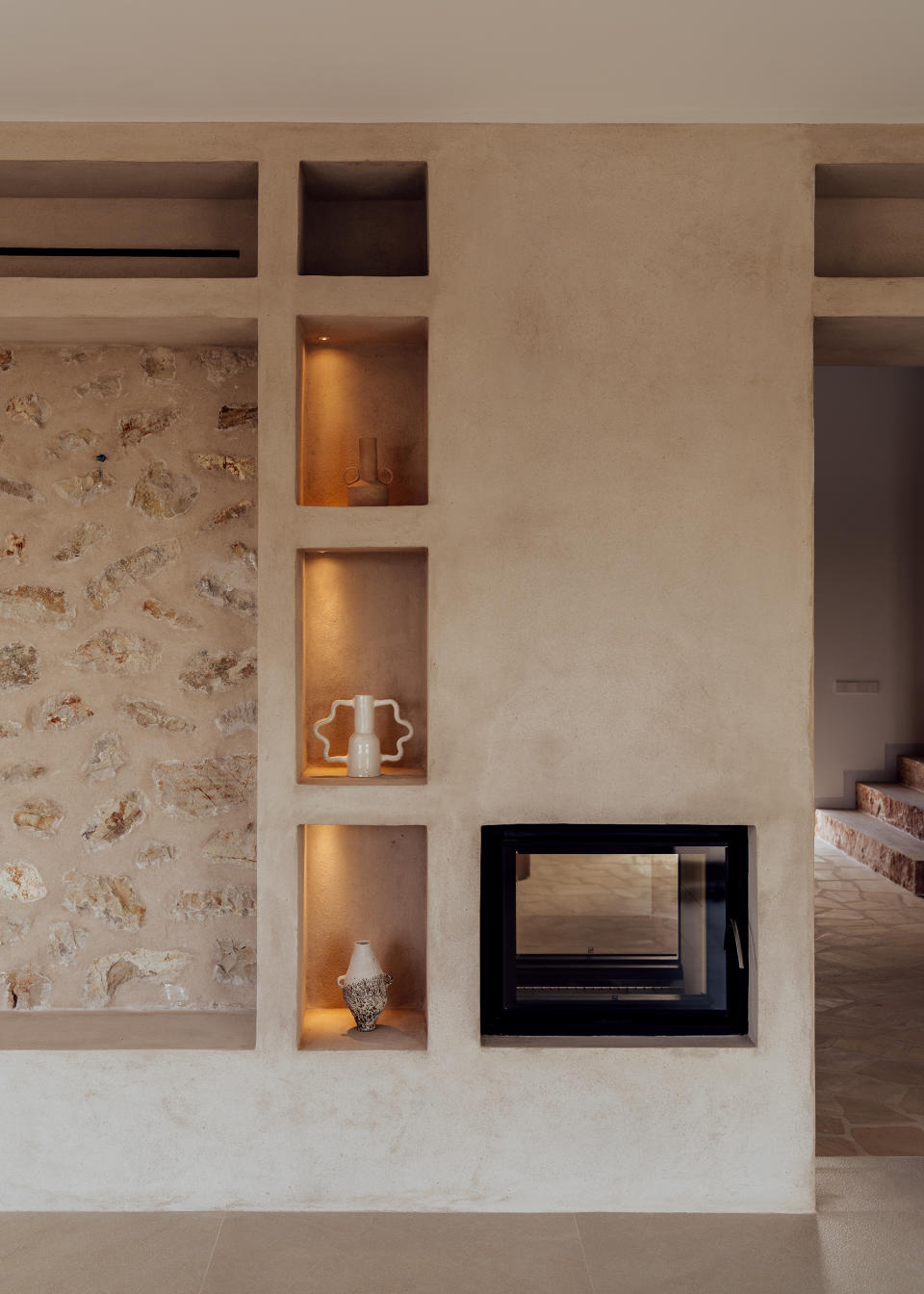 A hallway with light installed inside storage wall