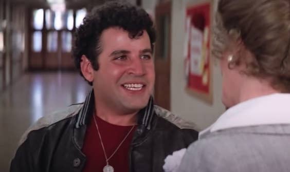 Michael Tucci talking to a teacher in "Grease"