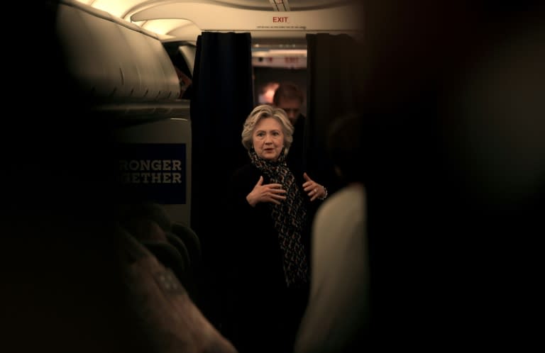 US Democratic presidential nominee Hillary Clinton on her aircraft enroute to the debate at Washington University in St. Louis, Missouri on October 9, 2016
