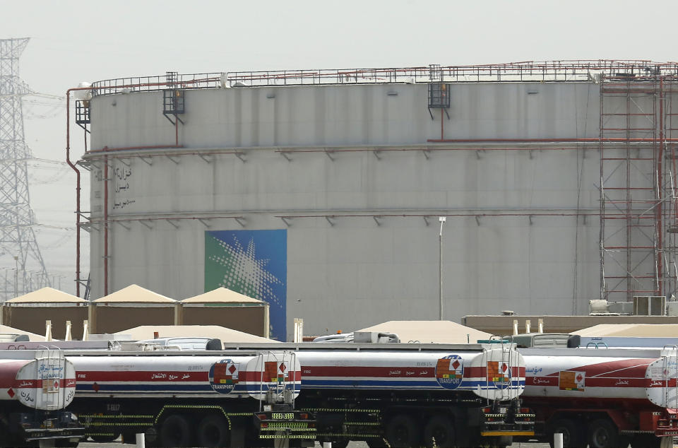 FILE - Fuel trucks line up in front of storage tanks at the North Jiddah bulk plant, an Aramco oil facility, in Jiddah, Saudi Arabia, on March 21, 2021. OPEC and allied oil-producing countries will decide on output levels Thursday Nov. 4 2021, with President Joe Biden urging alliance members Saudi Arabia and Russia to increase production and lower U.S. gasoline prices at the pump — so far to no avail. (AP Photo/Amr Nabil, File)