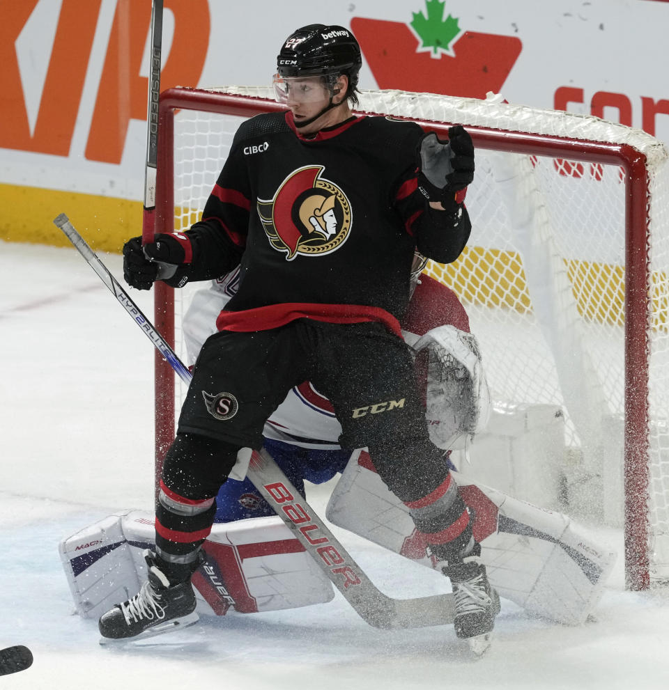 Ottawa Senators left wing Parker Kelly screens Montreal Canadiens goaltender Cayden Primeau as the puck enters the net during the second period of an NHL hockey game Thursday, Jan. 18, 2024, in Ottawa, Ontario. Kelly was called for goaltender interference and the goal was disallowed. (Adrian Wyld/The Canadian Press via AP)