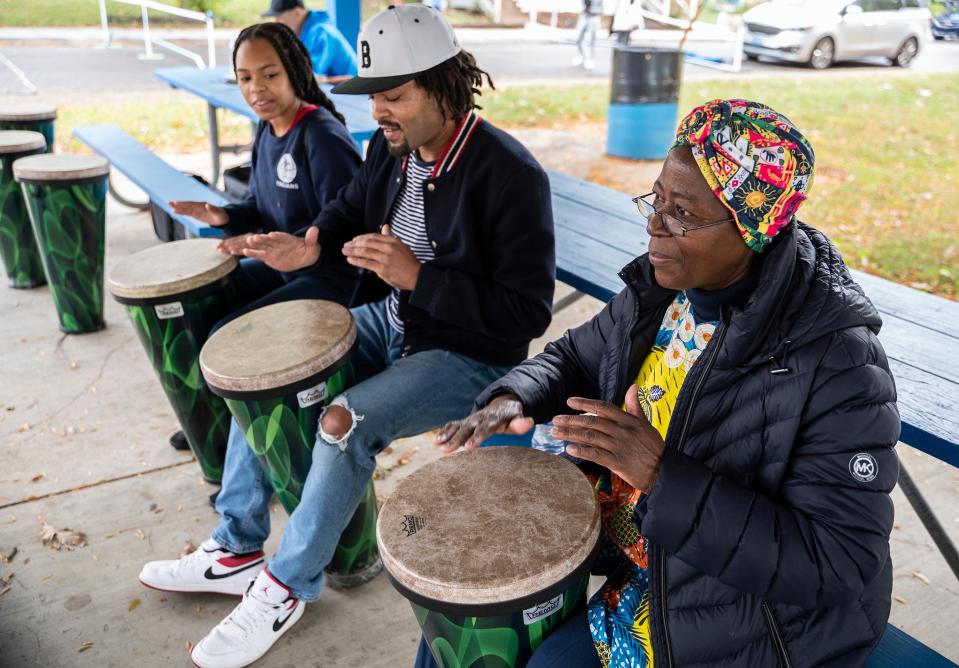 James Johnson and his daughter, Jayla Johnson, participate in a drum circle led by Sabina Santana at a neighborhood block party held at Frank Young Park. Santana is the founder of Shifting Ideas Through the Education of African Women, a nonprofit that helps empower and provide educational opportunities to vulnerable girls in Uganda and Kenya.