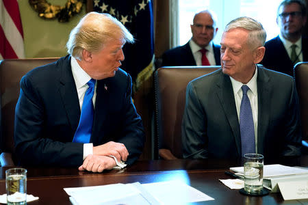 FILE PHOTO: U.S. President Donald Trump, flanked by Defense Secretary James Mattis (R), speaks to reporters before he holds a cabinet meeting at the White House in Washington, U.S. December 6, 2017. REUTERS/Jonathan Ernst/File Photo