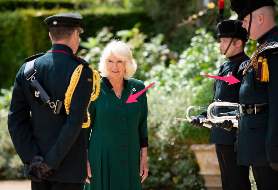 Camilla, then Duchess of Cornwall, wears a green coat and speaks to soldiers