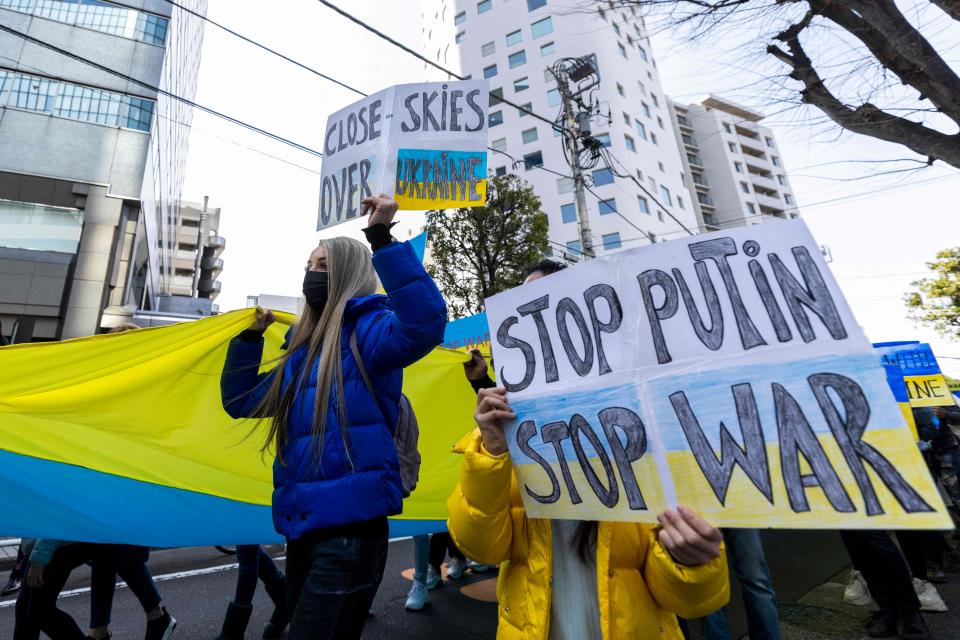 Protestors hold placards as they take part in a protest against Russia's actions in Ukraine during a rally in Tokyo.