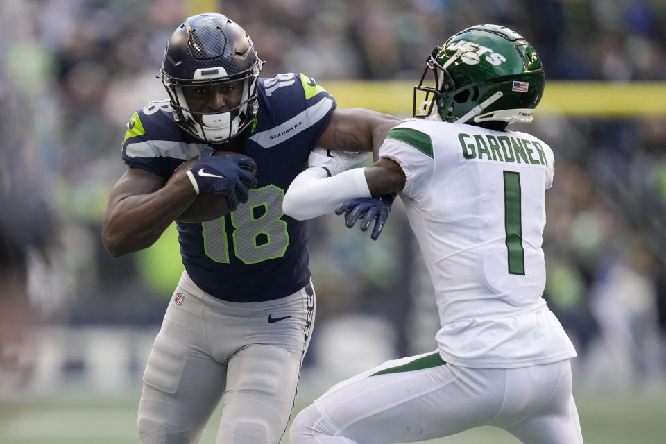 Seattle Seahawks wide receiver Laquon Treadwell (18) tries to escape the hit of New York Jets cornerback Sauce Gardner (1) during the second half of an NFL football game, Sunday, Jan. 1, 2023, in Seattle. (AP Photo/Godofredo A. Vásquez)