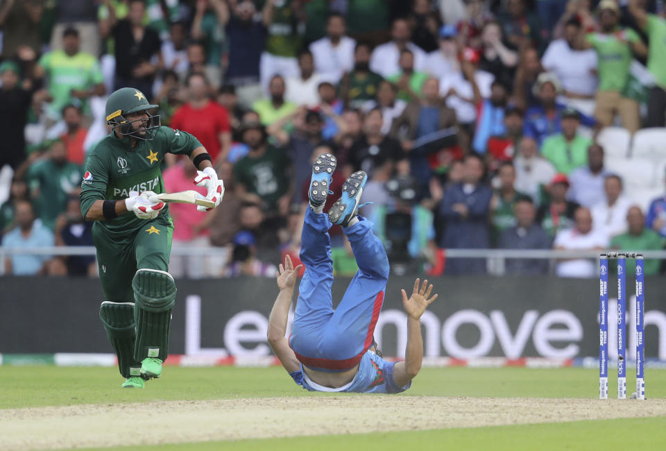 Afghanistan's captain Gulbadin Naib falls as he attempts to run-out Pakistan's Imad Wasim during the Cricket World Cup match between Pakistan and Afghanistan at Headingley in Leeds, England, Saturday, June 29, 2019. (AP Photo/Rui Vieira)