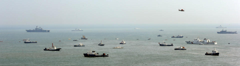 South Korean rescue teams try to search missing passengers of the sunken ferry Sewol in the water off the southern coast near Jindo, South Korea, Sunday, April 20, 2014. After more than three days of frustration and failure, divers on Sunday finally found a way into the submerged ferry off South Korea's southern shore, discovering more than a dozen bodies inside the ship and pushing the confirmed death toll to over four dozen, officials said. (AP Photo/Yonhap) KOREA OUT