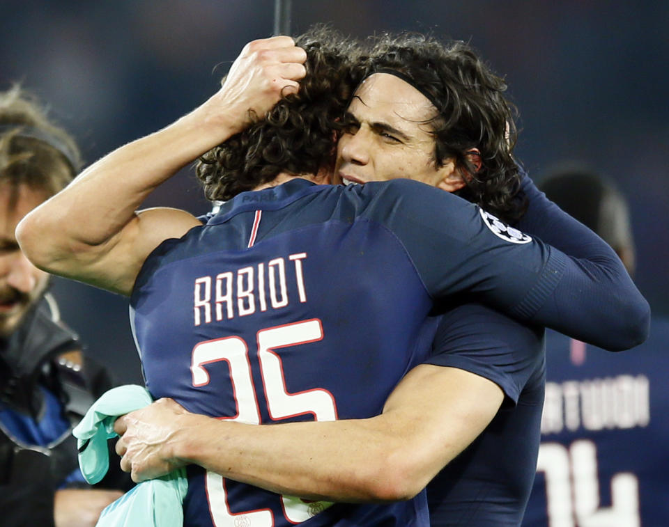 PSG's Edinson Cavani, right, celebrates with teammate Adrien Rabiot after the Champion's League round of 16, first leg soccer match between Paris Saint Germain and Barcelona at the Parc des Princes stadium in Paris, Tuesday, Feb. 14, 2017. PSG won the match 4-0. (AP Photo/Francois Mori)