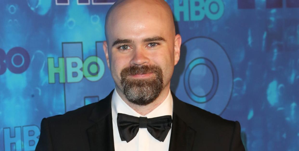 bryan cogman in a black and white suit with black bow tie