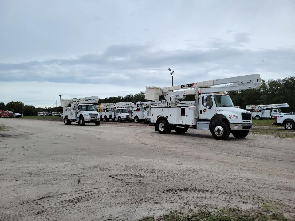 Florida Power and Light trucks use Sarasota’s Robarts Arena as a staging area as they get directed around the state to prepare for restoring power after Hurricane Ian.