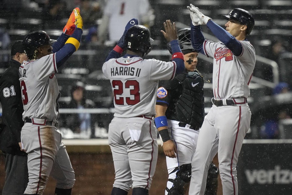 Atlanta Braves' Matt Olson, right, celebrates with Michael Harris II, middle and Ronald Acuna Jr. after hitting a three-run home run during the fifth inning of the team's baseball game against the New York Mets, Friday, April 28, 2023, in New York. (AP Photo/Bryan Woolston)