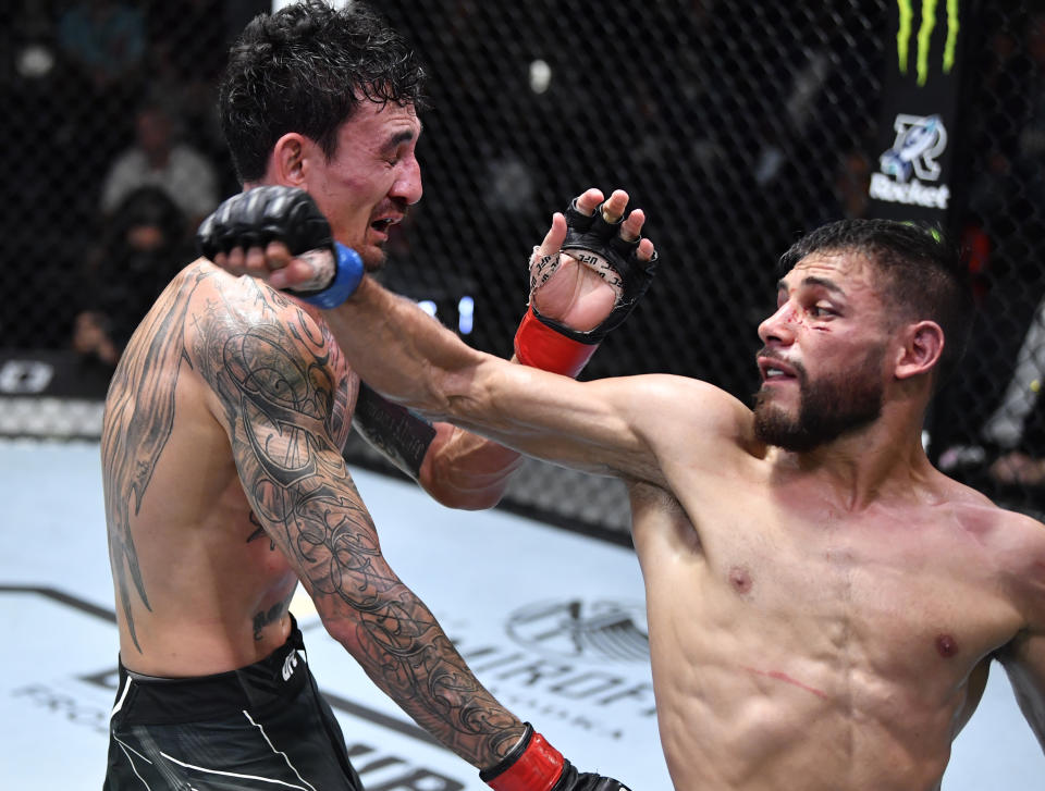 LAS VEGAS, NEVADA - NOVEMBER 13: (R-L) Yair Rodriguez of Mexico lands a spinning back fist against Max Holloway in a featherweight fight during the UFC Fight Night event at UFC APEX on November 13, 2021 in Las Vegas, Nevada. (Photo by Chris Unger/Zuffa LLC)