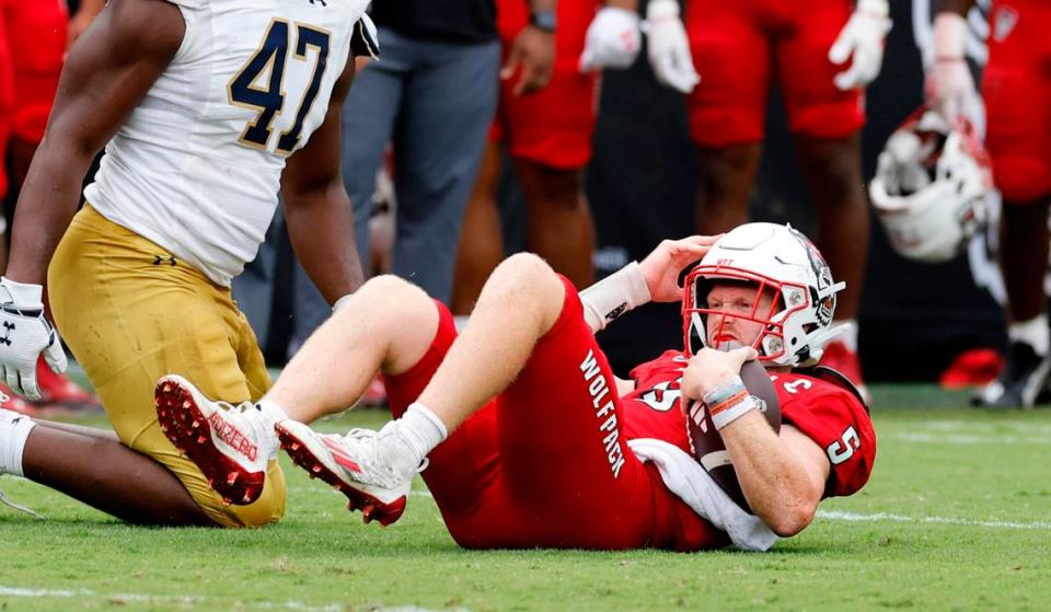 N.C. State quarterback Brennan Armstrong (5) lies on the ground after he was sacked by Notre Dame defensive lineman Donovan Hinish during the second half of Notre Dame’s 45-24 victory over N.C. State at Carter-Finley Stadium in Raleigh, N.C., Saturday, Sept. 9, 2023.