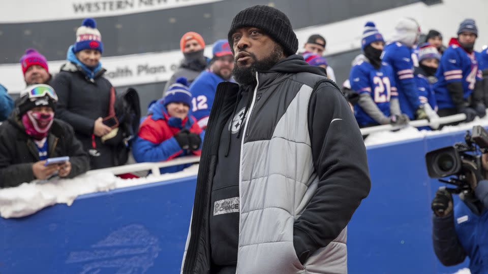 Tomlin walks onto the field before the Steelers' playoff game against the Bills. - Matt Durisko/AP