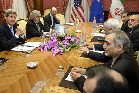 U.S. Secretary of State John Kerry (L) waits to start a meeting with Iranian officials at the Beau Rivage Palace Hotel in Lausanne March 29, 2015. REUTERS/Brendan Smialowski/Pool