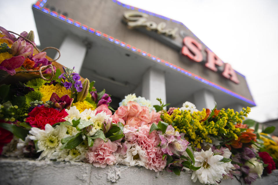 Flowers seen outside Gold Spa, one of the Atlanta-area spas targeted in a shooting spree that left eight people, including six Asian women, dead on Tuesday, March 16, 2021. (Elijah Nouvelage for The Washington Post via Getty Images)