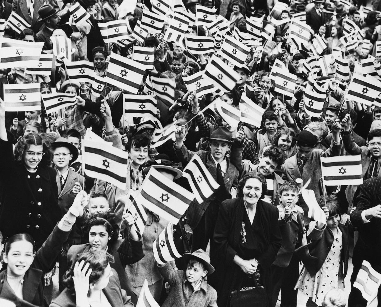 <span>Schoolchildren in Camden, New Jersey, wave Israeli flags in 1948.</span><span>Photograph: Bettmann/Bettmann Archive</span>