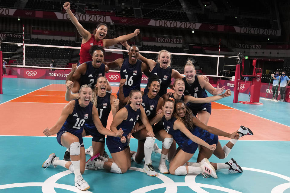 United States players celebrate winning the women's volleyball semifinal match between Serbia and United States at the 2020 Summer Olympics, Friday, Aug. 6, 2021, in Tokyo, Japan. (AP Photo/Frank Augstein)