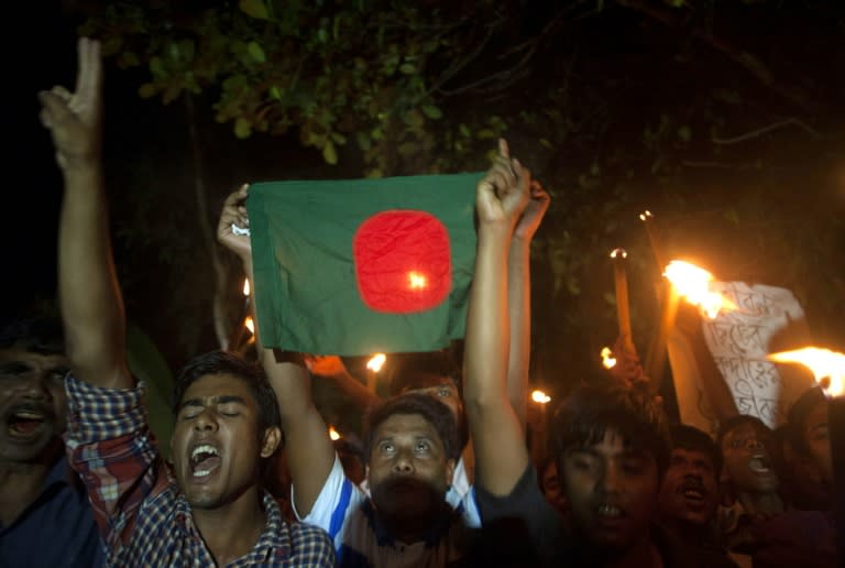 Former Indian enclave residents carry torches and a Bangladesh flag as they take part in a procession at Dasiarchhara, Kurigram in Bangladesh on August 1, 2015