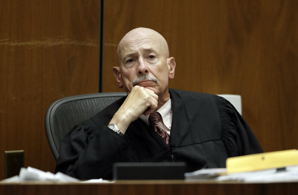 Judge Larry P. Fidler listens to closing arguments in the trial of People v. Michael Gargiulo Wednesday, Aug. 7, 2019, in Los Angeles. Closing arguments continued Wednesday in the trial of the air conditioning repairman charged with killing two Southern California women and attempting to kill a third. (AP Photo/Marcio Jose Sanchez, Pool)