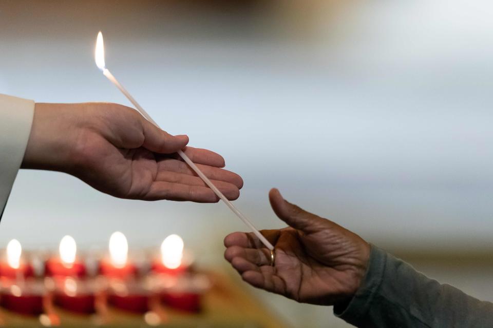 Australian politicians and religious leaders light candles at an interfaith service at St Marys Cathedral in Sydney on March 17, 2019.