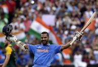 India's Shikhar Dhawan celebrates after reaching his century during the Cricket World Cup match against South Africa at the Melbourne Cricket Ground (MCG) February 22, 2015. REUTERS/Hamish Blair