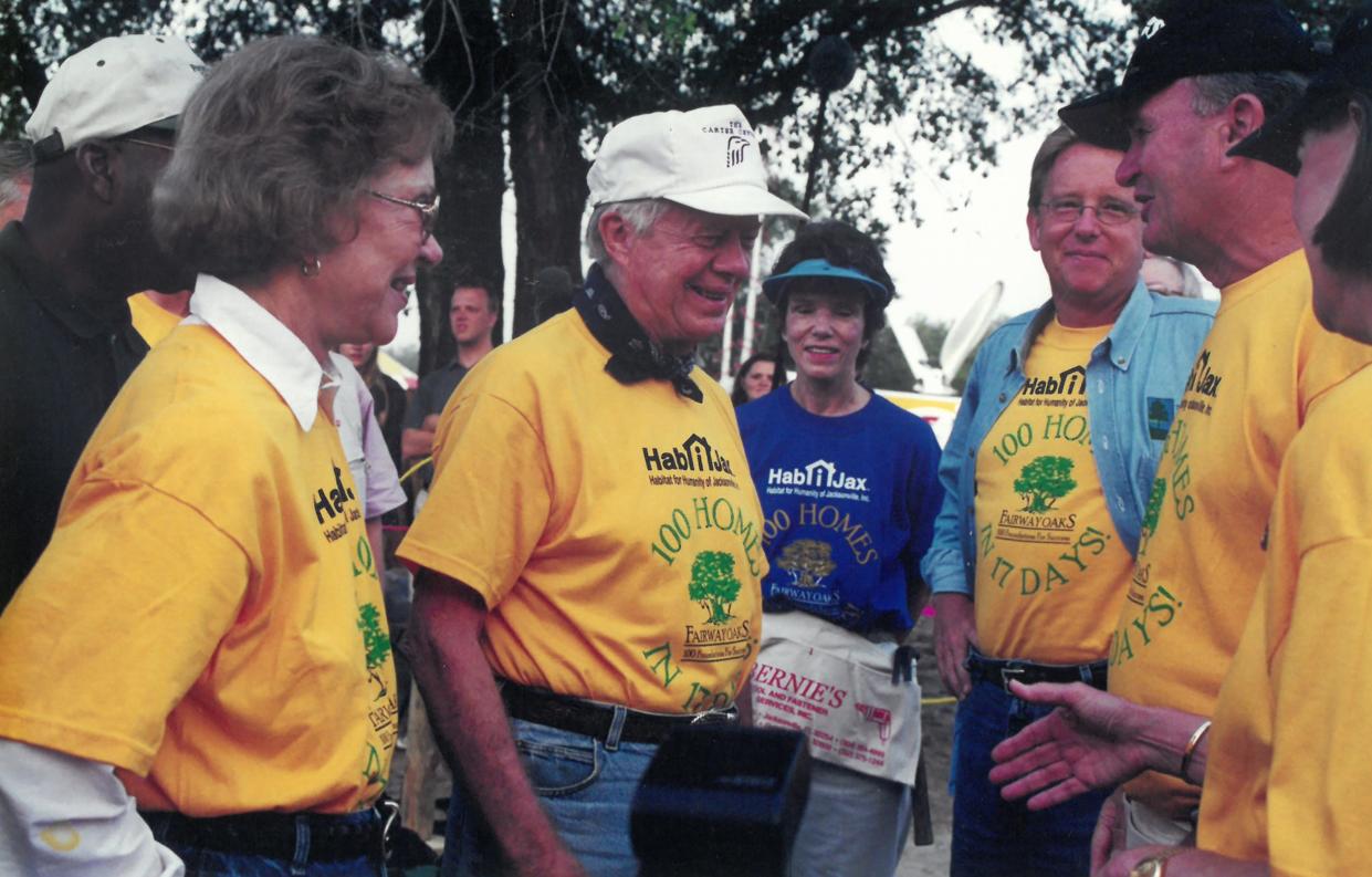 During Habitat for Humanity's 2000 Carter Work Project in Jacksonville, former President Jimmy Carter and wife Rosalynn chat with Ann Hicks (center, then left), then-Mayor John Delaney and Jaguars founders Wayne Weaver and Delores Barr Weaver.