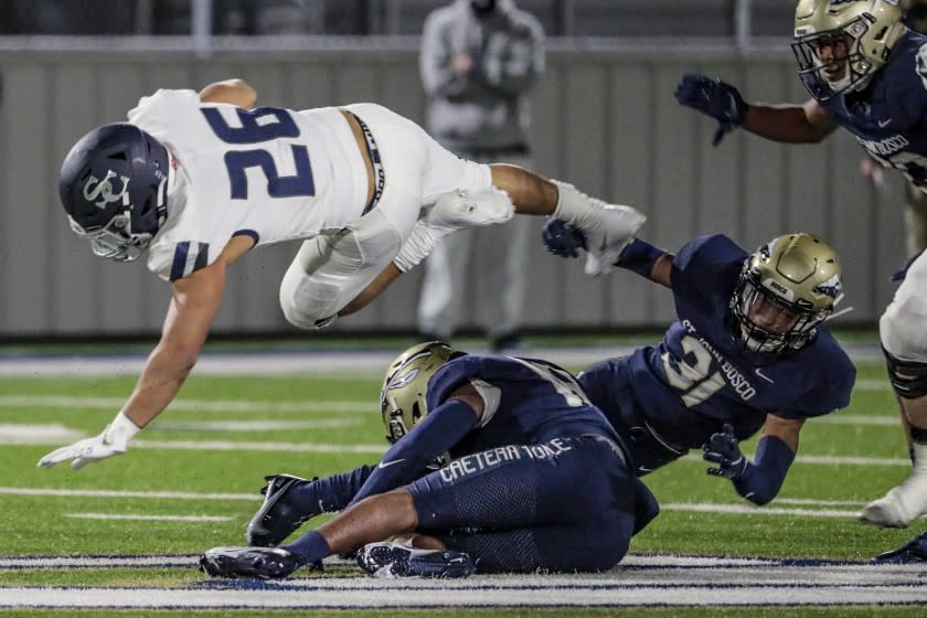 Bellflower, CA, Saturday March 13, 2021 - Sierra Canyon running back Anthony Spearman is tripped up by St. John Bosco defenders during a first half drive at Panish Family Stadium. (Robert Gauthier/Los Angeles Times)