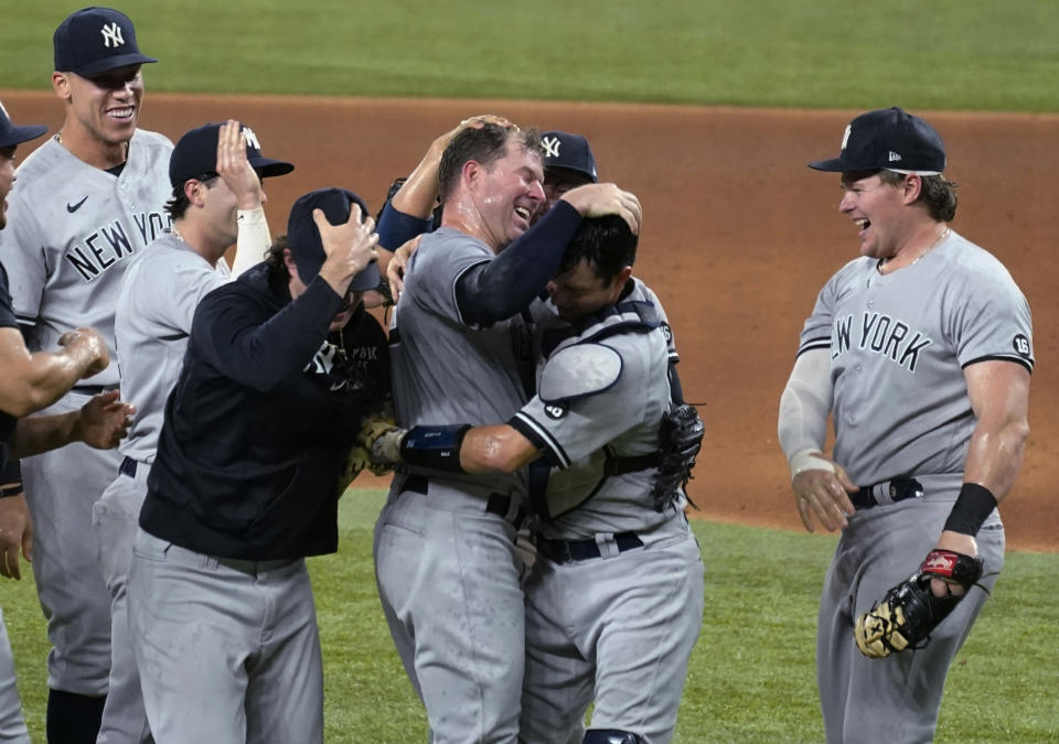 New York Yankees starting pitcher Corey Kluber, third from right, celebrates with catcher Kyle Higashioka, second from right, and the rest of the team after throwing a no-hitter against the Texas Rangers in a baseball game in Arlington, Texas, Wednesday, May 19, 2021. (AP Photo/Tony Gutierrez)