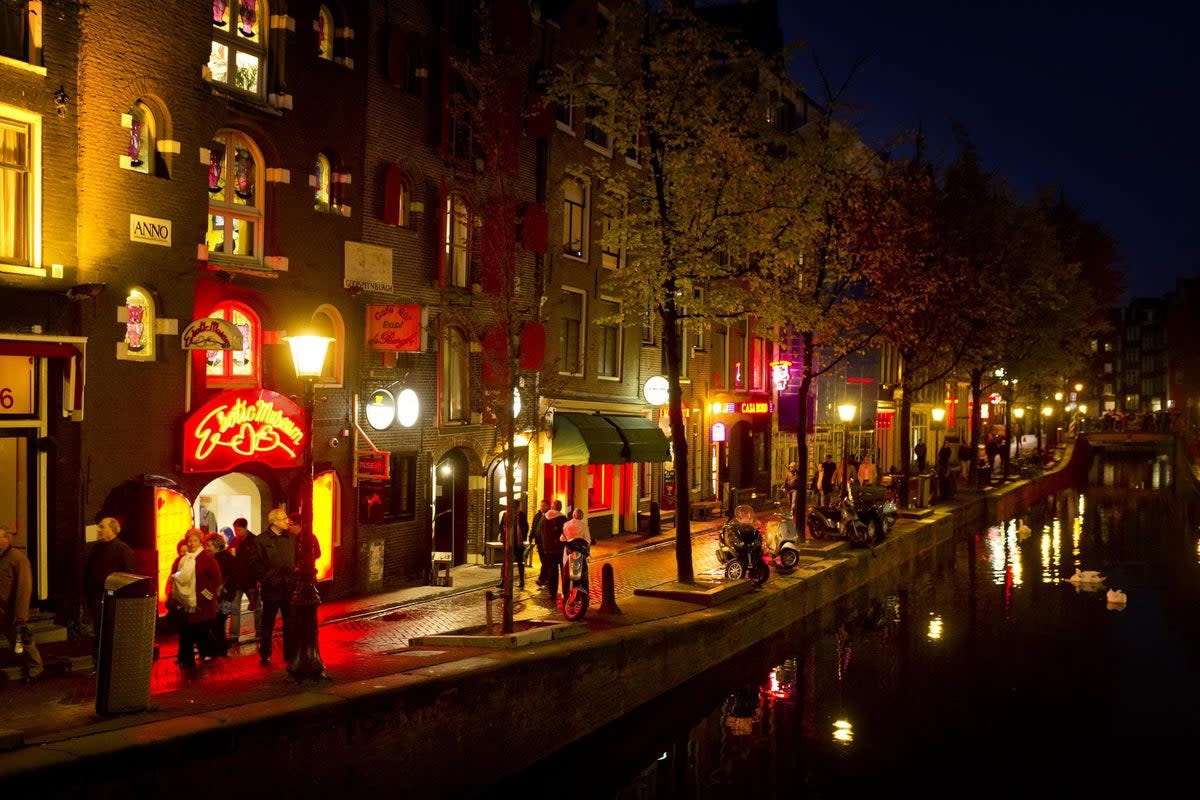 People walk through the red-light district, known as De Wallen, in Amsterdam. (AFP / Getty Images)