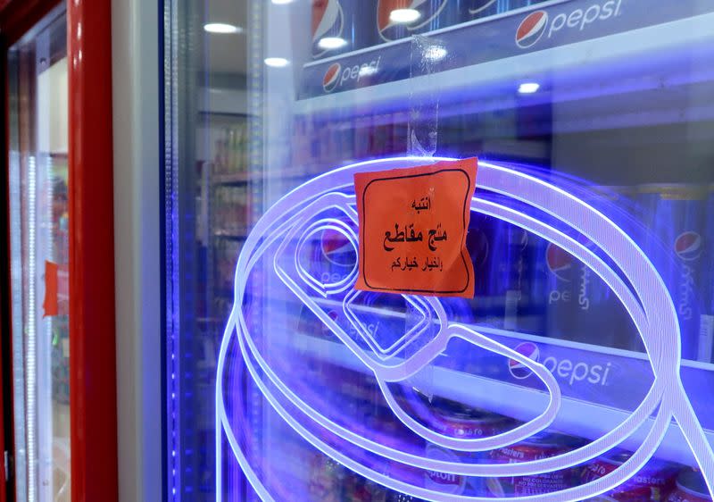 A sign reading: ' Warning: This product is boycotted. The choice is yours.' is seen at a supermaket in Amman