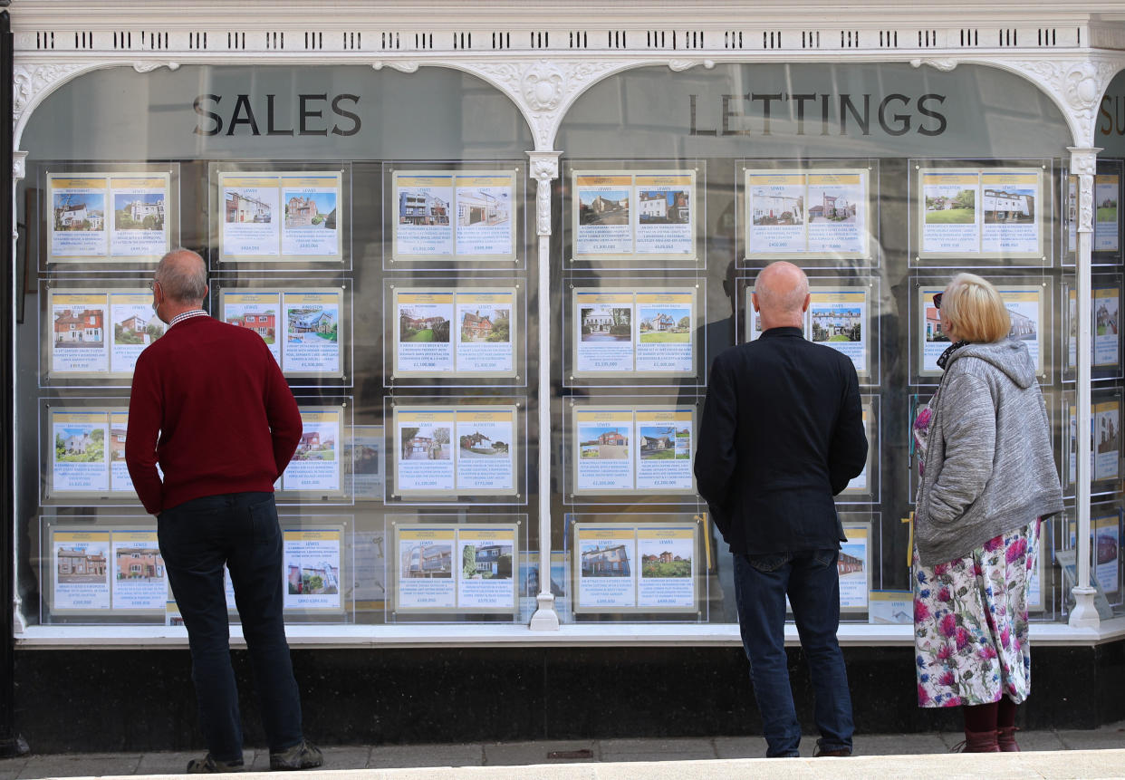 File photo dated 21/04/21 of people looking at house price signs displayed in the window of an estate agents. This year's housing market is on course to be the busiest since 2007, according to a property website. Issue date: Wednesday May 26, 2021.