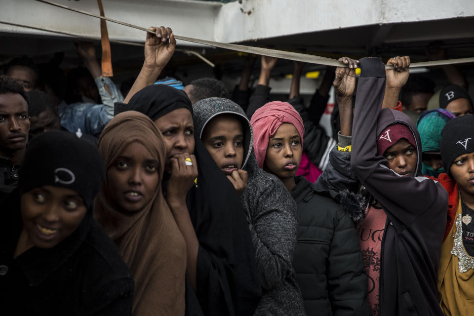 Migrants look out as they approach port, from the deck of the Spanish NGO Proactiva Open Arms rescue vessel, after being rescued Dec. 21, in the Central Mediterranean Sea, before disembarking in the port of Crinavis in Algeciras, Spain, Friday, Dec. 28, 2018. The Spanish NGO Proactiva Open Arms aid boat carrying over 300 migrants rescued at sea, has ended a weeklong journey across the western Mediterranean Sea to dock at the Spanish port of Algeciras on Friday. (AP Photo/Olmo Calvo)