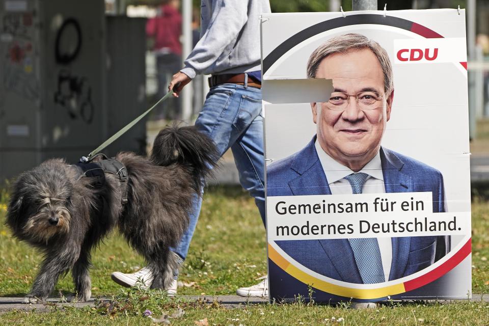 An election poster for the German Christian Democrats, CDU, shows top candidate Armin Laschet at a street in Duesseldorf, Germany, Wednesday, Aug. 25, 2021. A large chunk of the German electorate remains undecided going into an election that will determine who succeeds Angela Merkel as chancellor after 16 years in power. Recent surveys show that support for German political parties has flattened out, with none forecast to receive more than a quarter of the vote. (AP Photo/Martin Meissner)