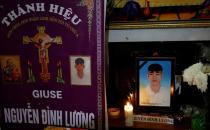 Images of Nguyen Dinh Luong, a victim who was found dead in the back of British truck, are seen at his home after his funeral in Ha Tinh province