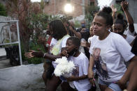 Relatives of Emily Victoria Silva dos Santos, 4, and Rebeca Beatriz Rodrigues dos Santos, 7, mourn during their burial at a cemetery in Duque de Caxias, Rio de Janeiro state, Brazil, Saturday, Dec. 5, 2020. Grieving families held funerals for Emily and Rebeca, killed by bullets while playing outside their homes. Weeping and cries of “justice” were heard Saturday at their funerals, reflecting the families’ assertion that the children were killed by police bullets. (AP Photo/Silvia Izquierdo)