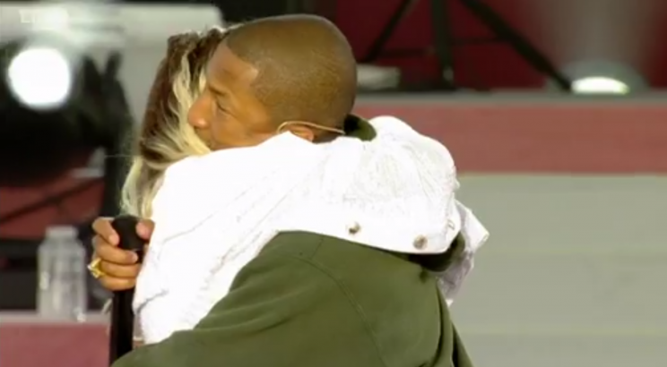 Pharrell and Miley share an embrace.