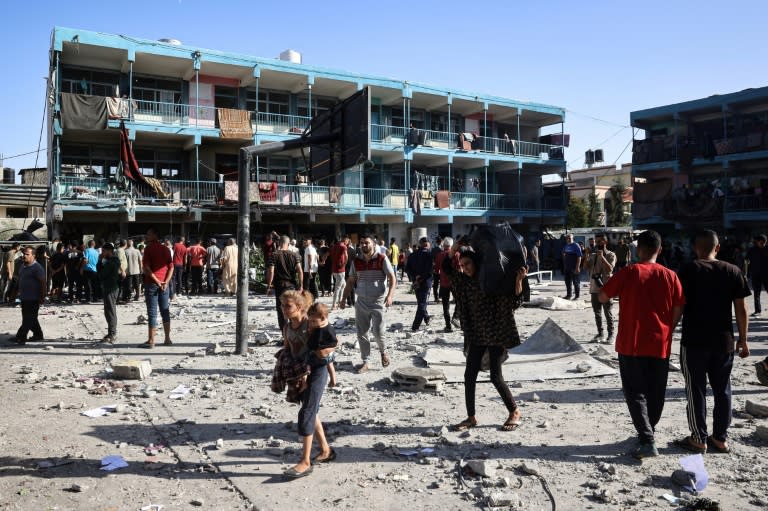 Palestinians in the courtyard of central Gaza's Al-Jawni school after an Israeli air strike (Eyad BABA)