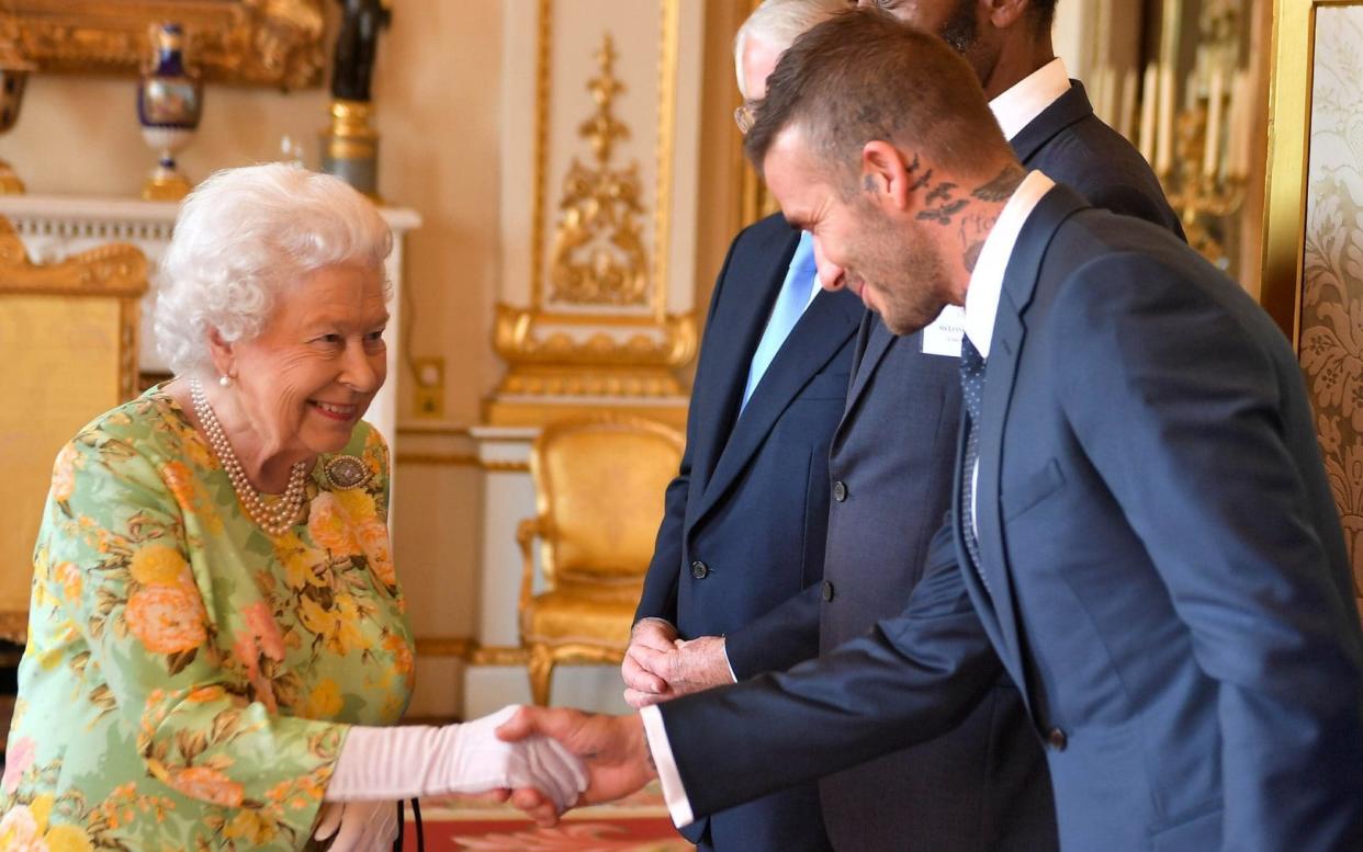 The Queen meeting David Beckham at Buckingham Palace - REUTERS