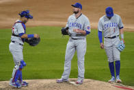Chicago Cubs starting pitcher Jon Lester, center, catcher Willson Contreras, left, and third baseman Kris Bryant wait for pitching coach Tommy Hottovy during the fourth inning of the team's baseball game against the Chicago White Sox in Chicago, Saturday, Sept. 26, 2020. (AP Photo/Nam Y. Huh)