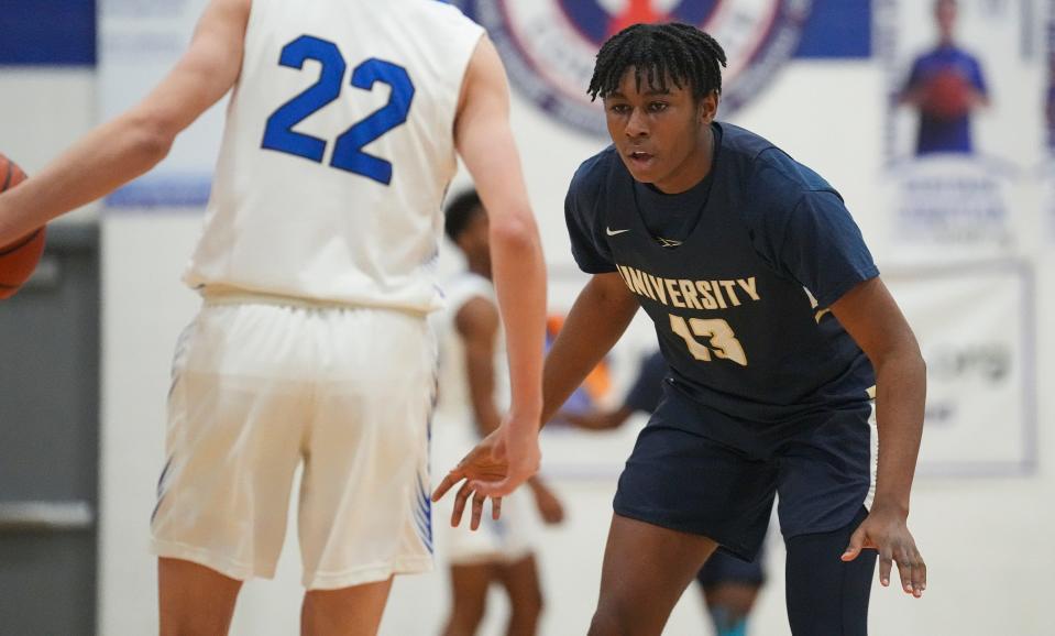 University Trailblazer Sabien Cain (13) guards Heritage Christian Eagle Cole Louden (22) on Saturday, Feb. 4, 2023, during a game at Heritage Christian High School in Indianapolis. 