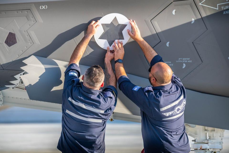 Israeli Air Force technicians customize an F-35I plane with a Star of David symbol.