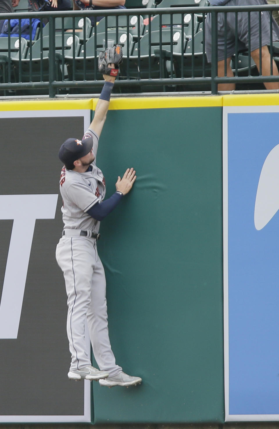 Houston Astros' Kyle Tucker goes up against the right field wall trying to catch a two-run home run hit by Detroit Tigers' Zack Short during the fifth inning of the first baseball game of a doubleheader Saturday, June 26, 2021, in Detroit. The Tigers defeated the Astros 3-1. (AP Photo/Duane Burleson)