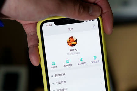 Pan Weida, 31, shows Xiaomi's app on his phone in Shanghai, China February 10, 2018. REUTERS/Aly Song